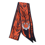 Orange and black tiger patterned scarf on a white background