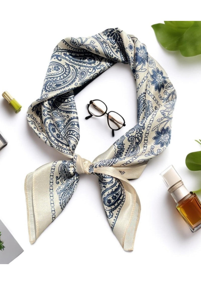 Blue and white patterned scarf with glasses and a bottle on a white background