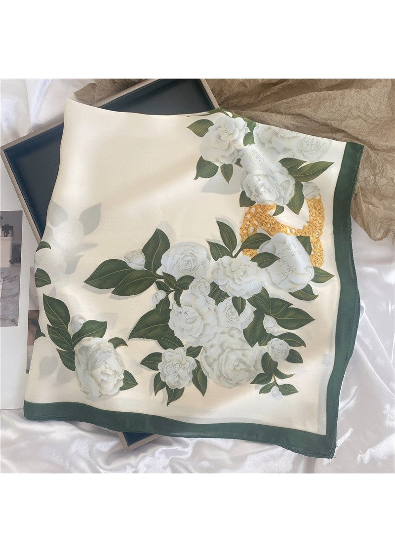 Floral patterned fabric with white flowers and green leaves on a beige background