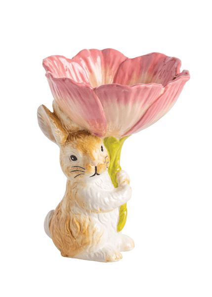 Ceramic rabbit holding a pink flower on a white background