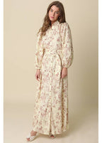 Woman wearing a floral dress against a beige background