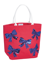 Red tote bag with blue bow patterns on a white background