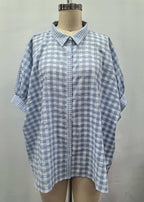Blue and white checkered shirt on a mannequin against a plain background