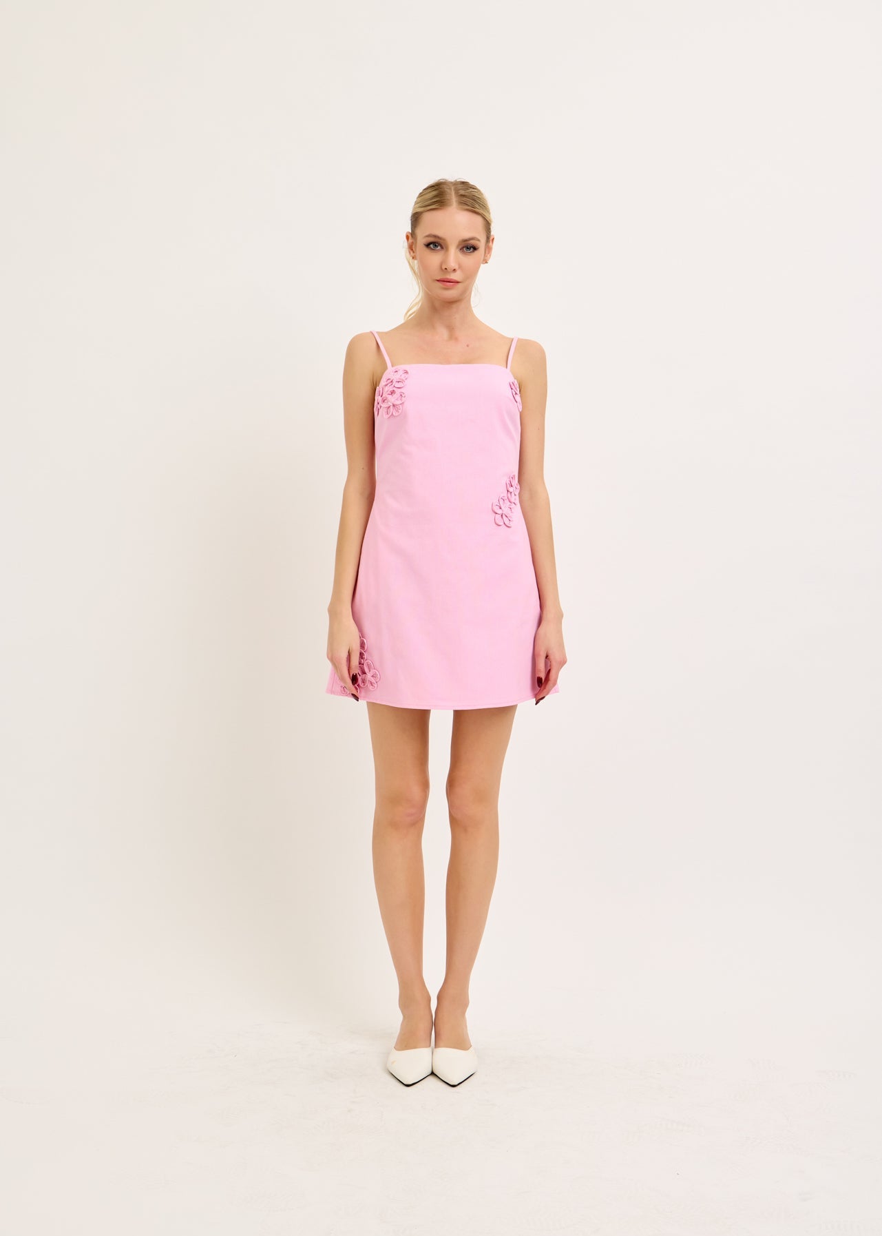 Woman wearing a pink dress on a white background