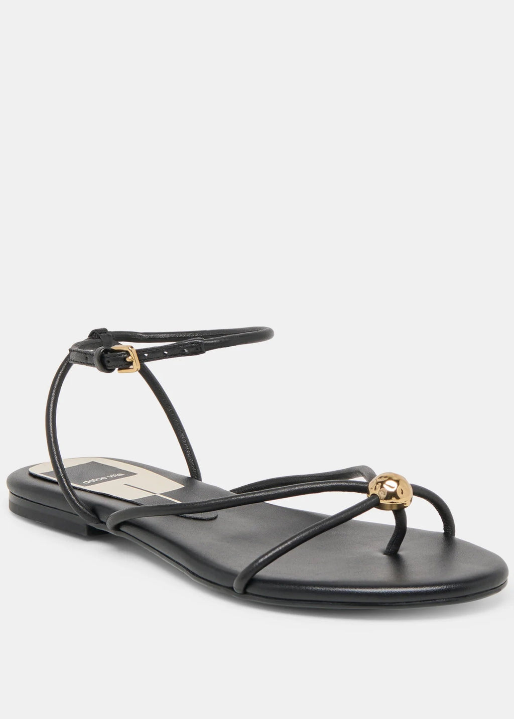 Black sandal with thin straps and gold accents on a white background