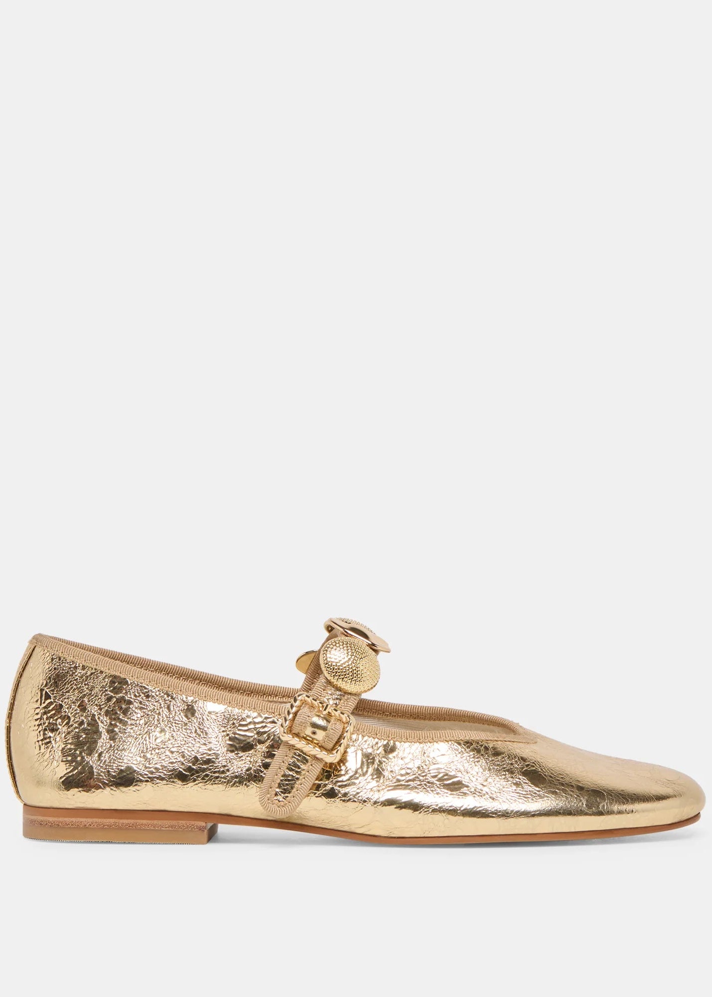 Gold metallic flat shoe with a decorative buckle on a white background