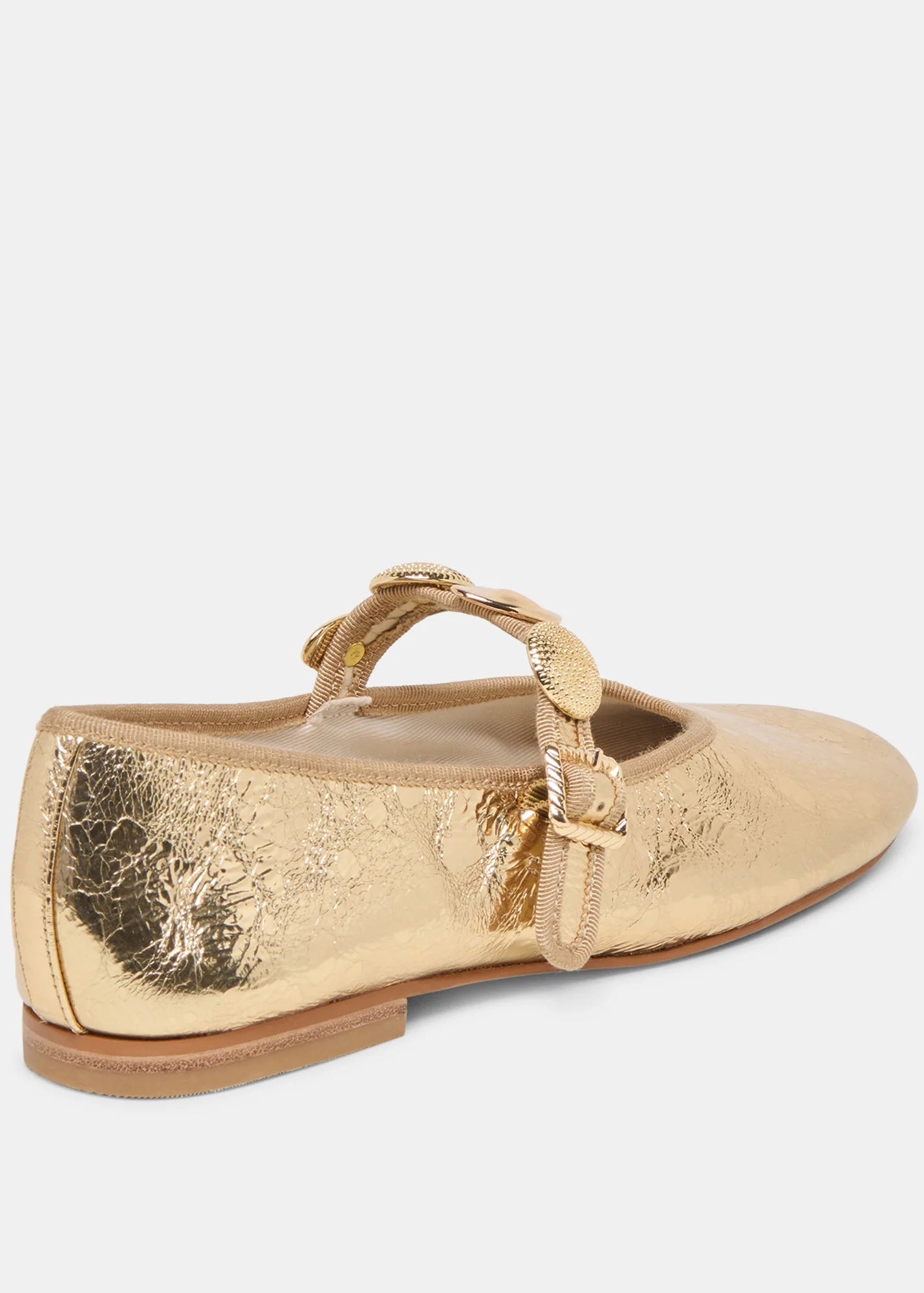 Gold flat shoe with a strap on a white background