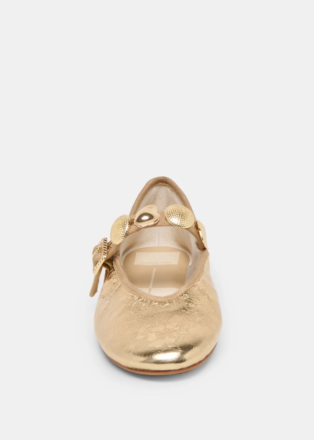 Gold ballet flat shoe on a light gray background