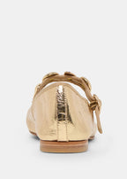 Gold metallic flat shoe on a white background