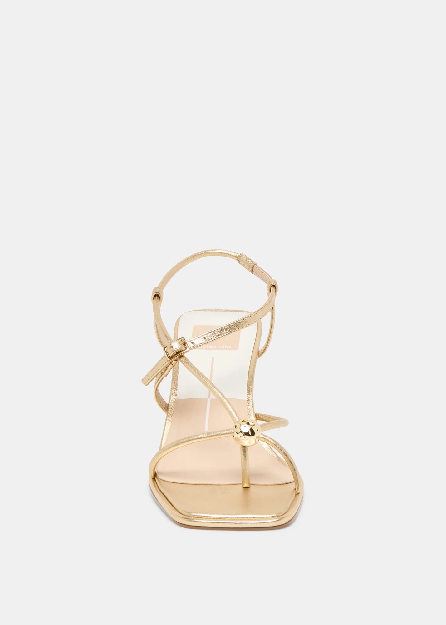 Gold high-heeled sandal on a light gray background