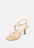 Gold high-heeled sandal on a white background