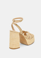 Beige wedge sandal with woven design on a white background
