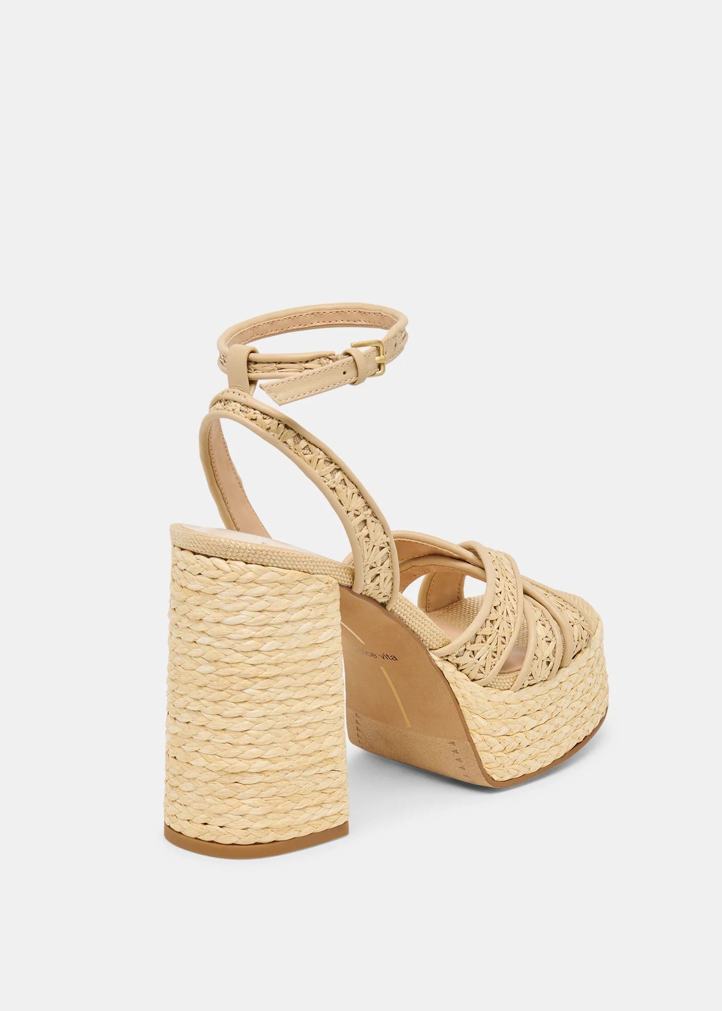 Beige wedge sandal with woven design on a white background
