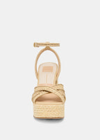 Beige sandal with woven design on a light gray background