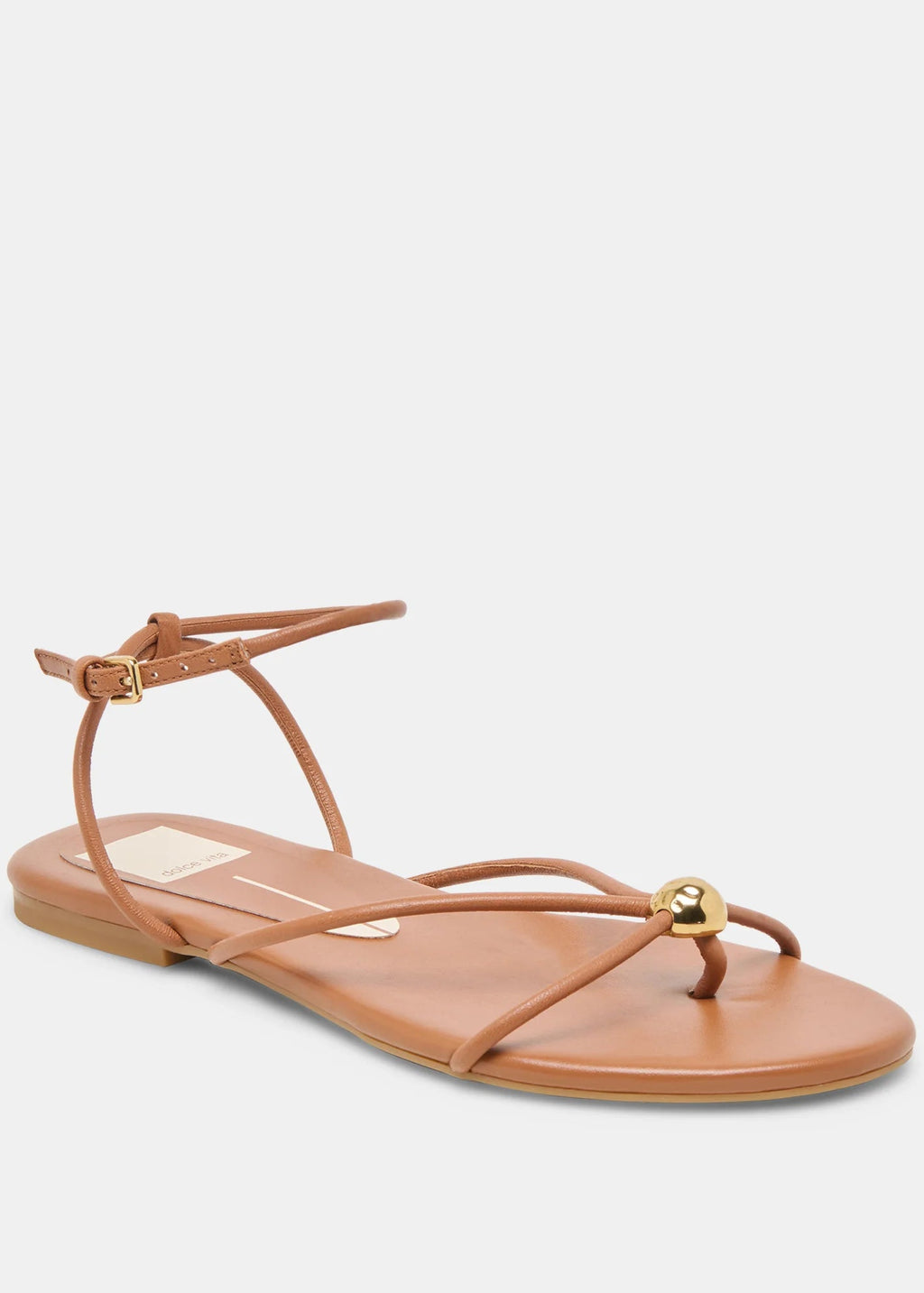 Tan sandal with thin straps on a light gray background