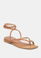 Tan sandal with thin straps on a white background