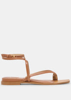 Tan sandal with thin straps on a light gray background