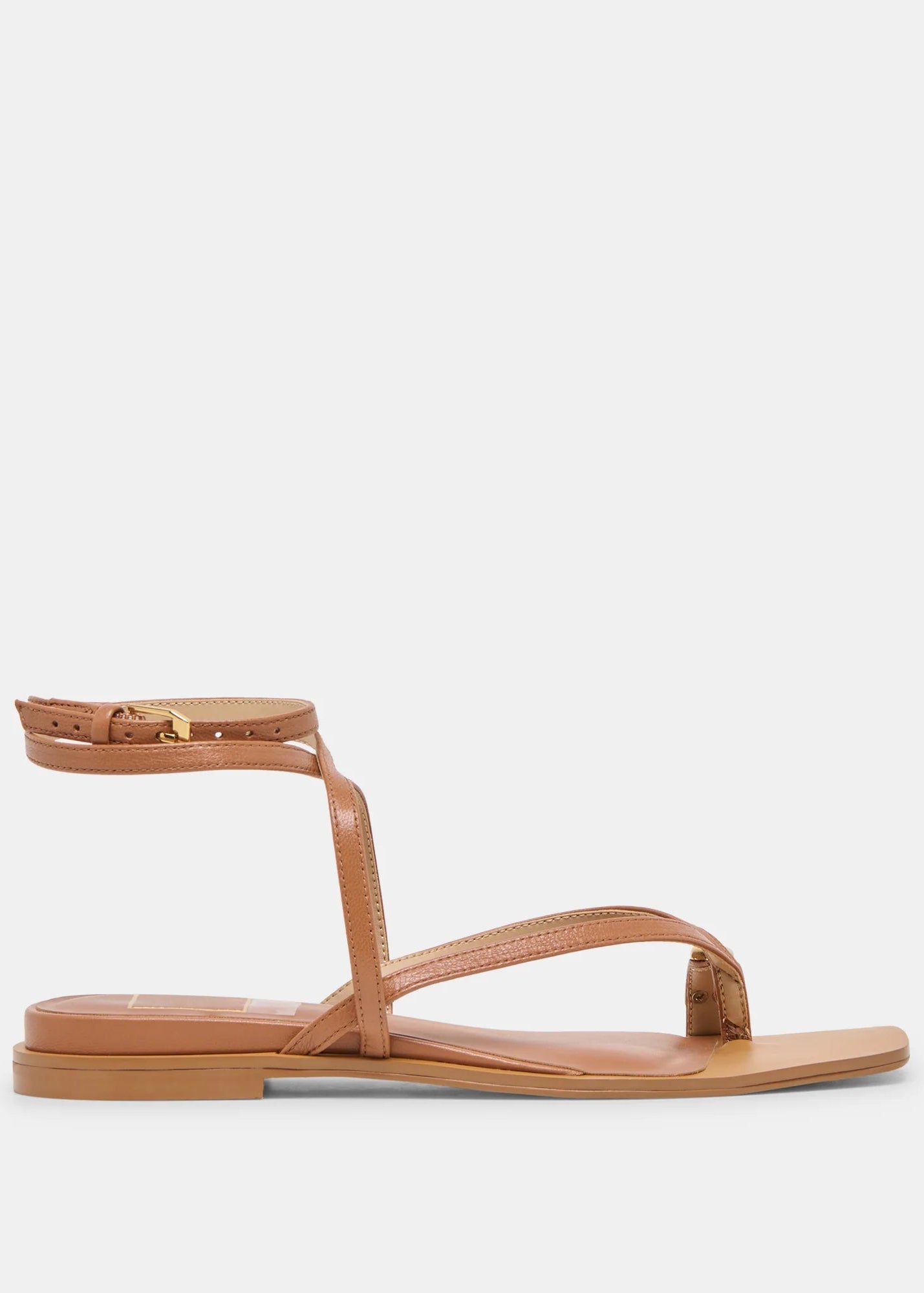 Tan sandal with thin straps on a light gray background