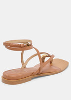 Tan sandal with thin straps on a white background