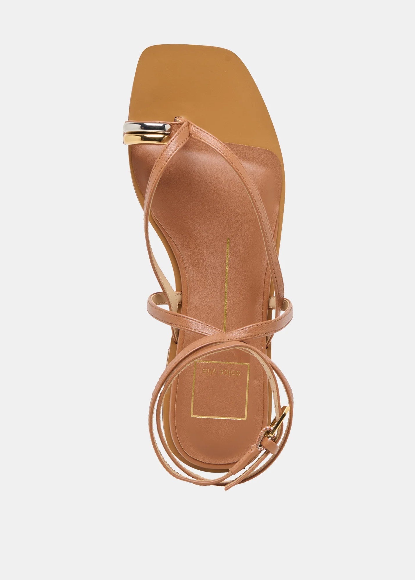 Tan sandal with thin straps on a white background