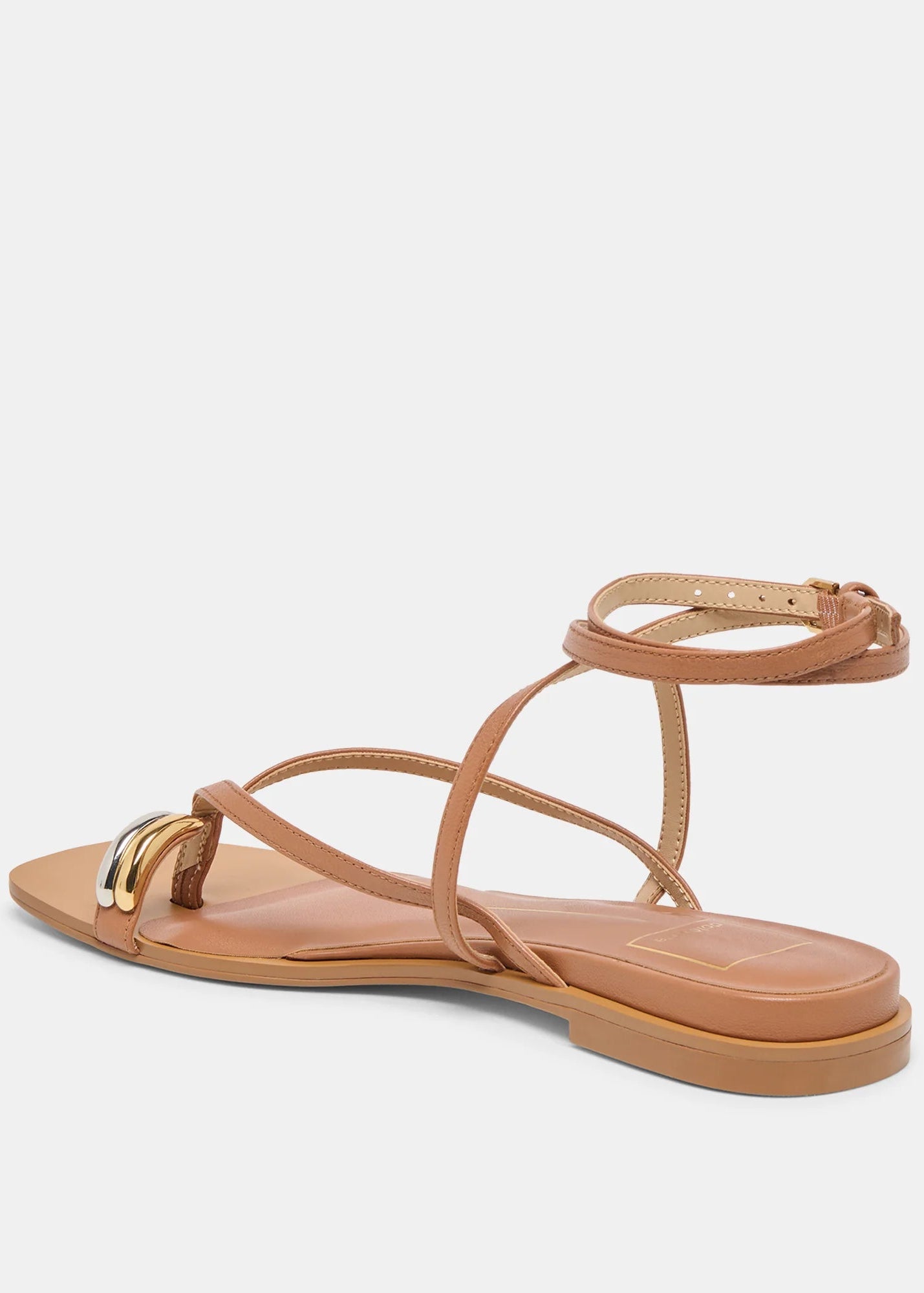 Tan sandal with thin straps on a light beige background