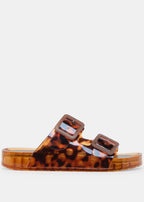 Tortoiseshell jelly sandal with brown buckles on a light gray background