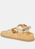 Gold sandal with woven sole on a white background