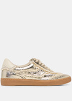 Gold metallic sneaker with a white background
