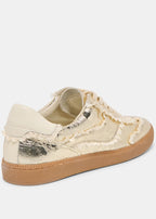 Beige sneaker with gold accents on a white background