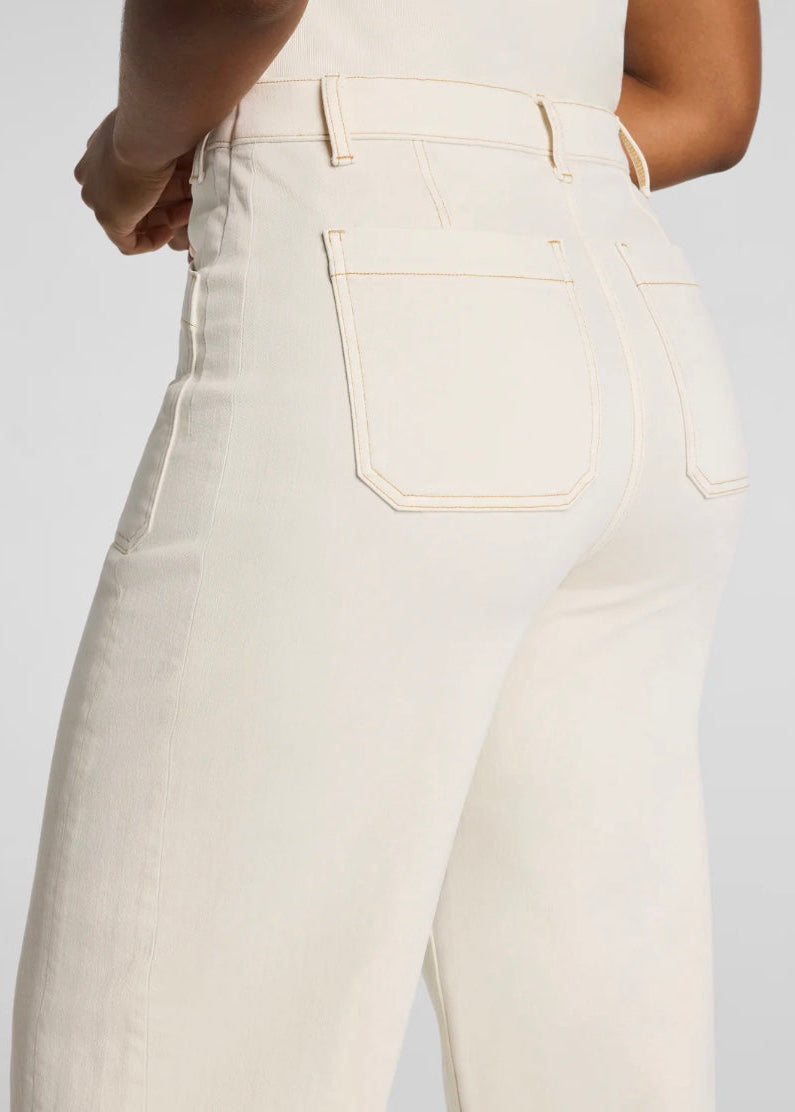 White jeans worn by a person on a white background