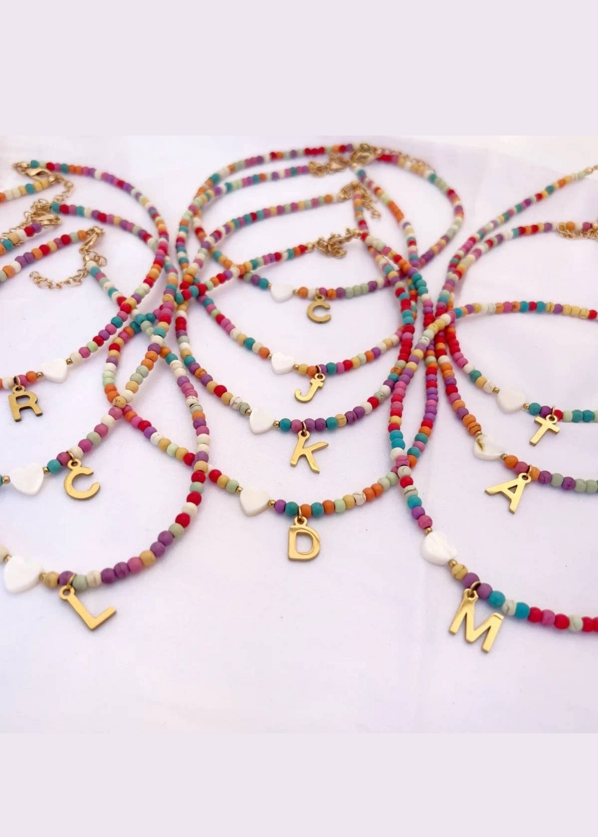 Beaded initial pendant necklace in a gold finish