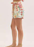 Floral wrap skirt worn by a person on a plain background