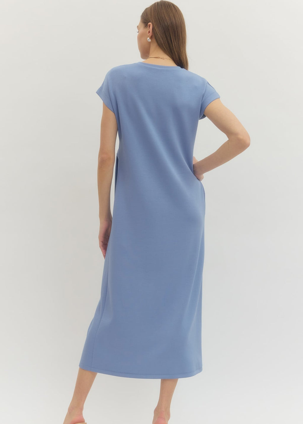 Woman wearing a blue dress on a white background