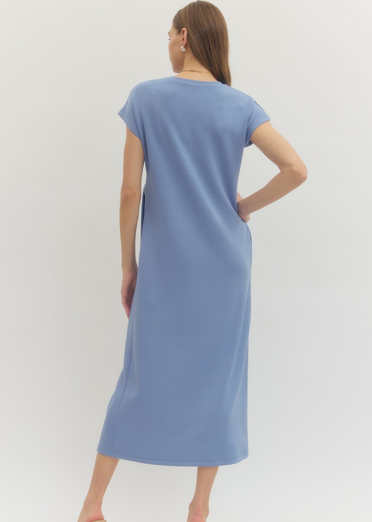 Woman wearing a blue dress on a white background