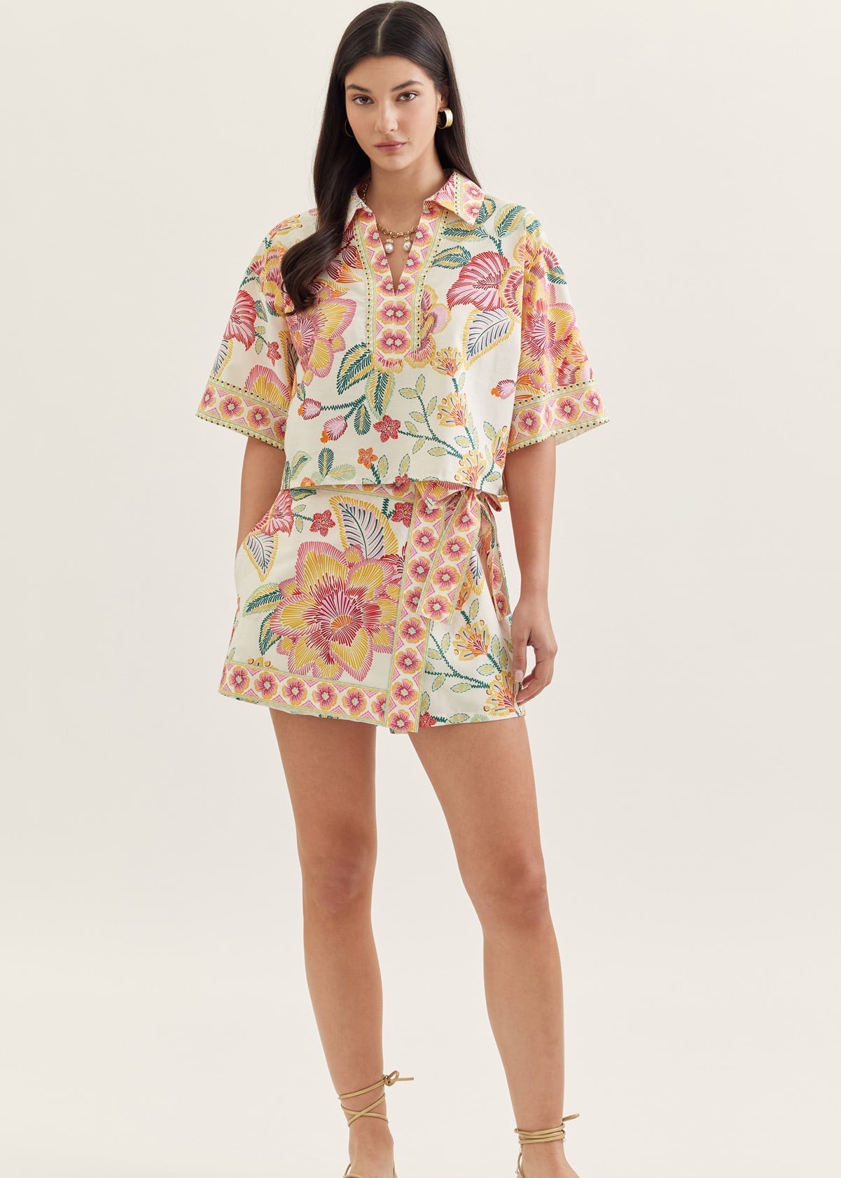 Woman wearing a floral outfit on a white background