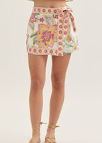Floral patterned skirt worn by a person on a white background