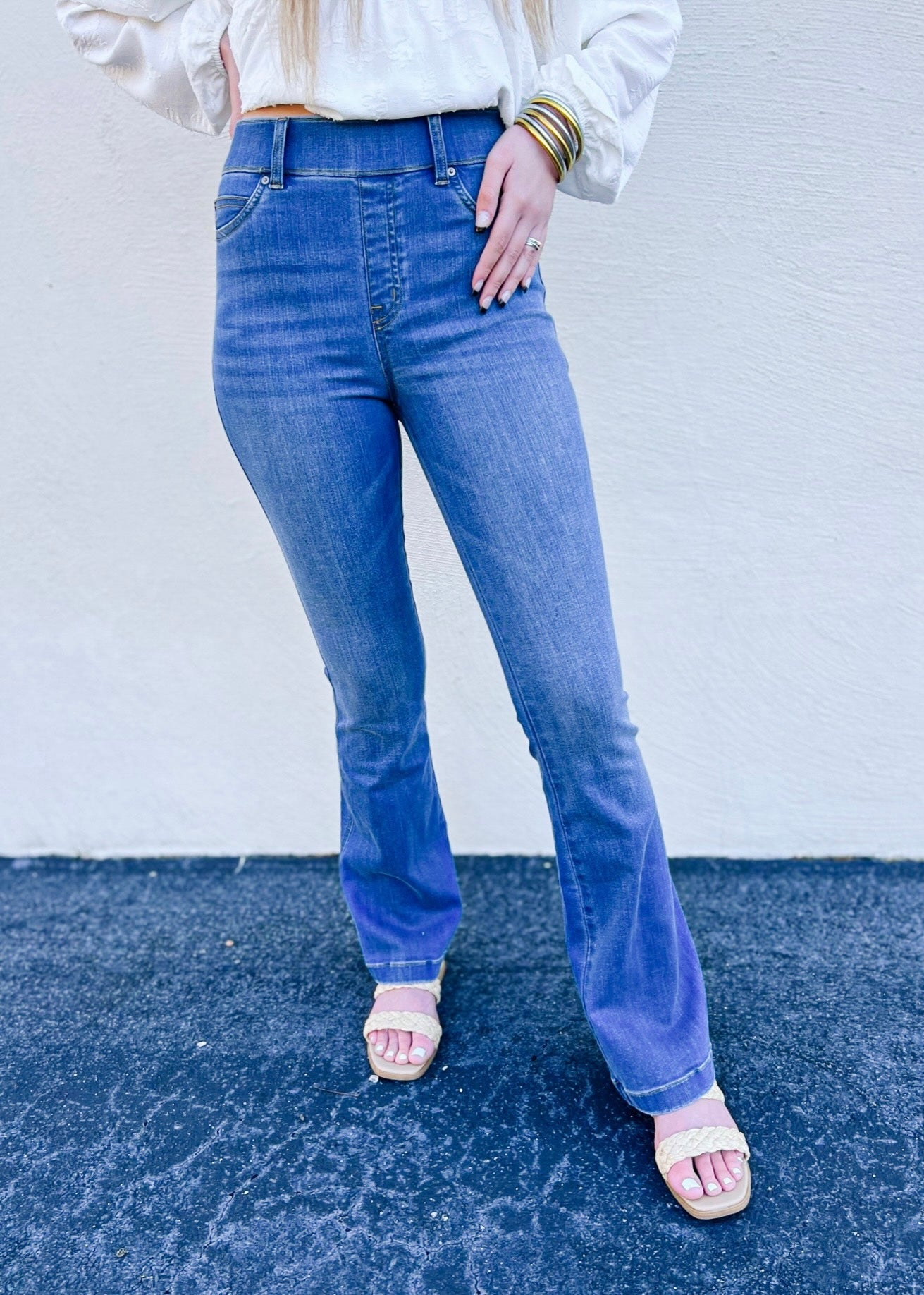 Model is wearing the Spanx flare jeans in Medium Wash, which are designed with premium stretch and are sure to be your next pair of go to denim! This is a full length style and also features a pull on style.