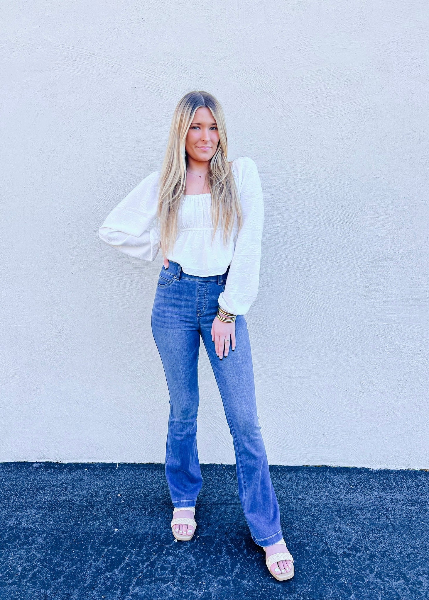 Model is wearing the Spanx flare jeans in Medium Wash, which are designed with premium stretch and are sure to be your next pair of go to denim! This is a full length style and also features a pull on style.